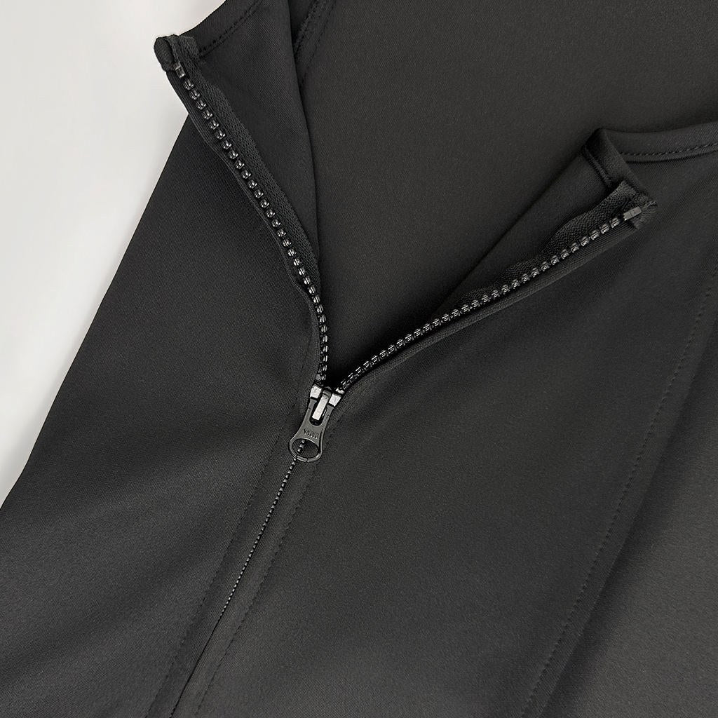 Close-up of the side zipper on the black vest