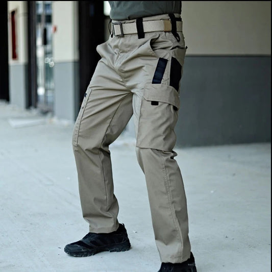 Phantom Tactical Pant in khaki worn with a belt, side view of the flapped cargo pocket and black contrast panels