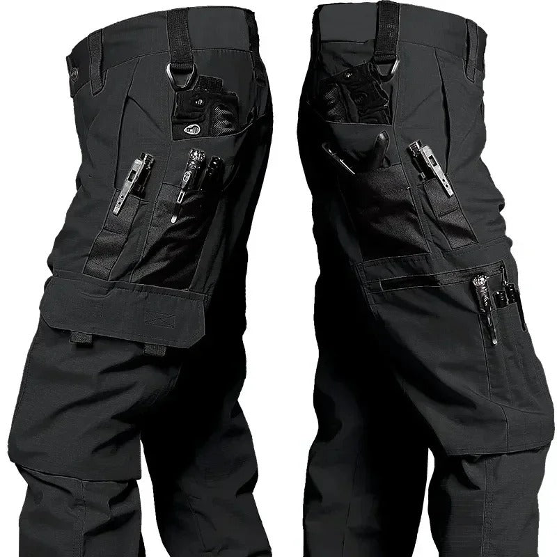 Black Phantom Tactical Pant, thigh pockets holding pens, a small flashlight and a multitool, D-rings at the waist