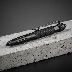 Phantom Tactical Pen: knurled metal body, pocket clip and glass-breaker tip on a concrete block
